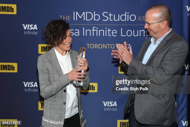 Founder and CEO of IMDb Col Needham presents actress Tatiana Maslany with The IMDb 'Fan Favorite' STARmeter Award In Toronto At The Visa Infinite...