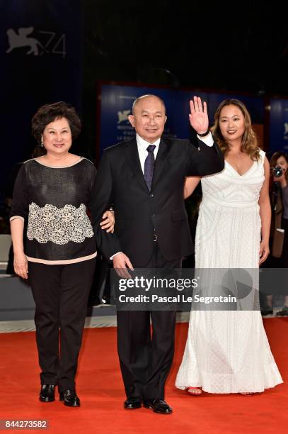 Annie Woo Ngau Chun-lung, John Woo and Angeles Woo walk the red carpet ahead of the 'Manhunt ' screening during the 74th Venice Film Festival at Sala...