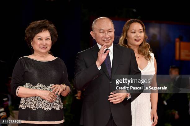 Annie Woo Ngau Chun-lung, John Woo wearing a Jaeger-LeCoultre watch and Angeles Woo walk the red carpet ahead of the 'Manhunt ' screening during the...