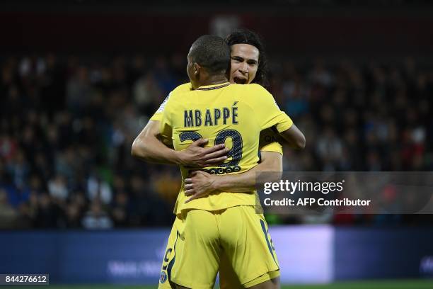 Paris Saint-Germain's Uruguayan forward Edinson Cavani celebrates with Paris Saint-Germain's French forward Kylian Mbappe after Cavani scored the...