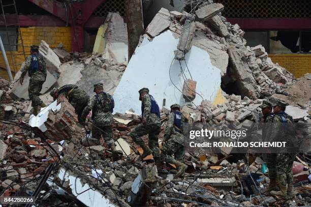 Mexican Navy members walk amid debris of the Town Hall building which partially collapsed following an 8.2 magnitude earthquake that hit Mexico's...