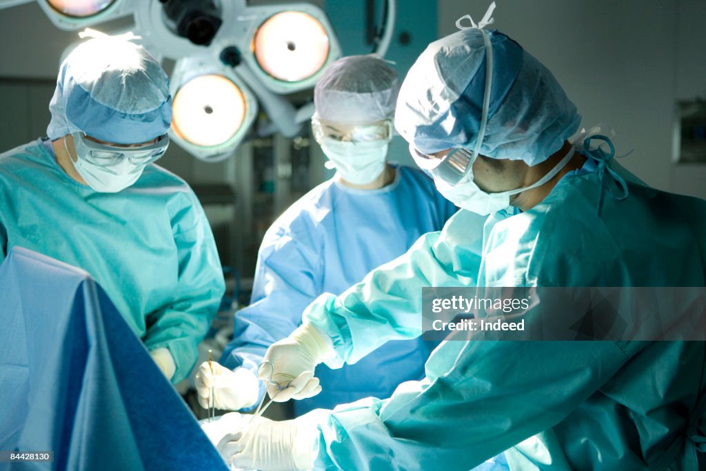 Surgeons operating using surgical equipment