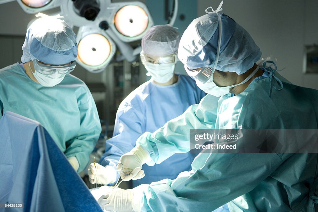 Surgeons operating using surgical equipment