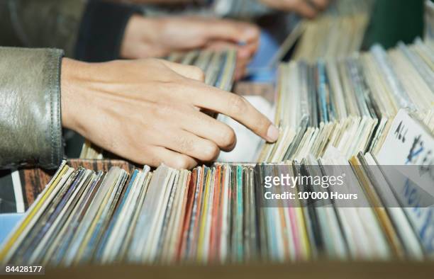 cu on hands searching through vintage records  - disco fotografías e imágenes de stock