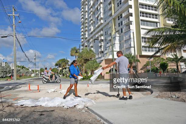 Liz Hankins and James Kiernan, of North Lauderdale, fill trash bags with sand on Pompano Beach in preparation for Hurricane Irma on Friday, Sept. 8,...