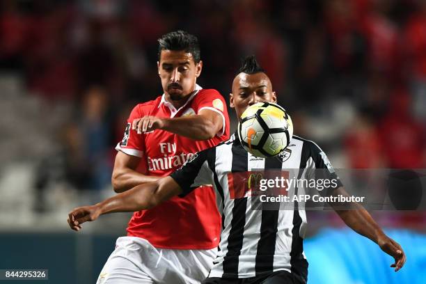 Benfica's defender Andre Almeida vies with Portimonense's Brazilian midfielder Fabricio Messias during the Portuguese league football match SL...