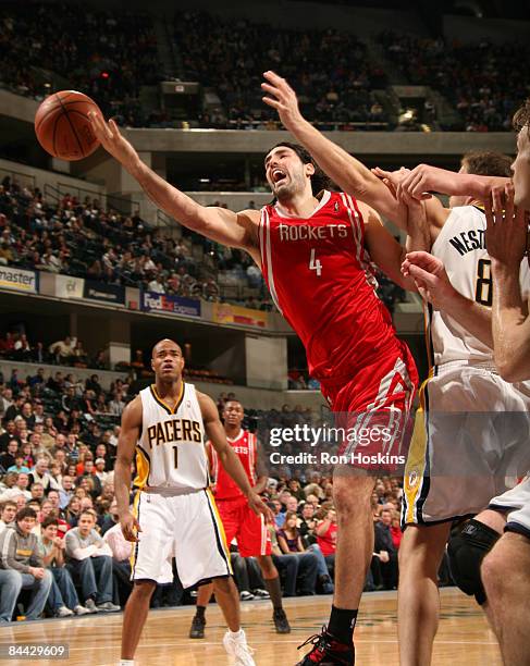 Luis Scola of the Houston Rockets shoots around Rasho Nestrovic of the Indiana Pacers at Conseco Fieldhouse on January 23, 2009 in Indianapolis,...