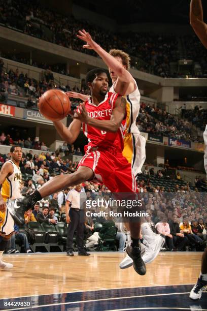 Aaron Brooks of the Houston Rockets passes the ball as Troy Murphy of the Indiana Pacers defends at Conseco Fieldhouse on January 23, 2009 in...