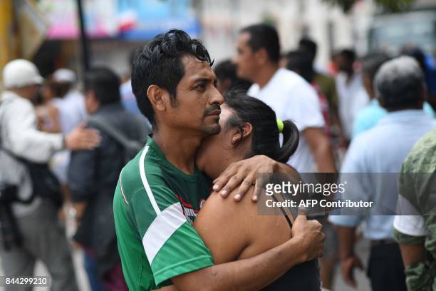 Couple embraces on September 8, 2017 in Juchitan de Zaragoza, state of Oaxaca, where buildings collapsed after an 8.2 earthquake that hit Mexico's...