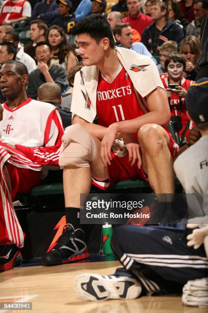 Yao Ming of the Houston Rockets sits on the bench as the Rockets take on the Indiana Pacers at Conseco Fieldhouse on January 23, 2009 in...