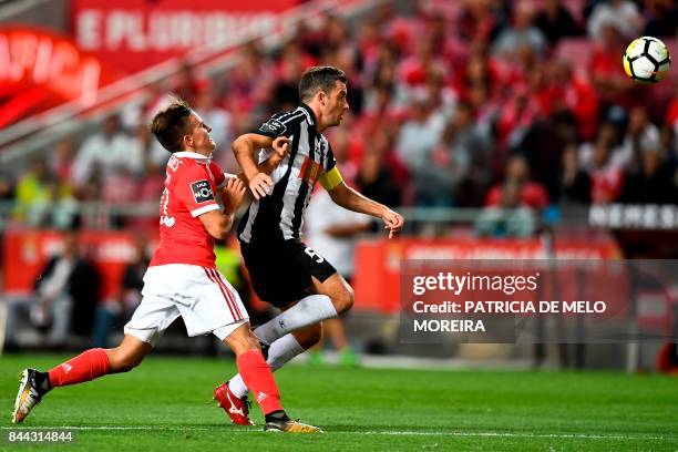 Portimonense's defender Ricardo Pessoa vis with Benfica's Argentine forward Franco Servi during the Portuguese league football match SL Benfica vs...