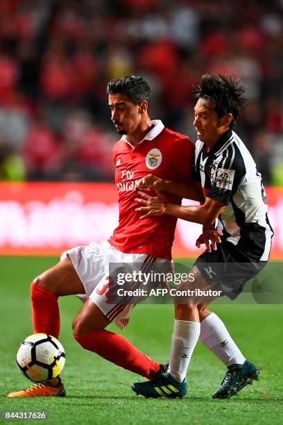 Benfica's defender Andre Almeida vies with Portimonense's Japanese forward Nakajima Shoya during the Portuguese league football match SL Benfica vs...