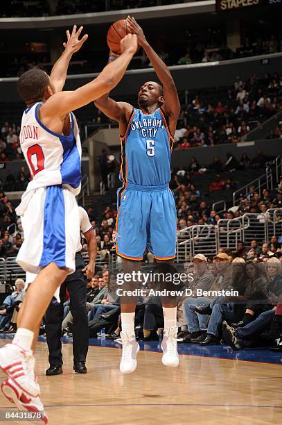 Kyle Weaver of the Oklahoma City Thunder shoots against Eric Gordon of the Los Angeles Clippers at Staples Center on January 23, 2009 in Los Angeles,...