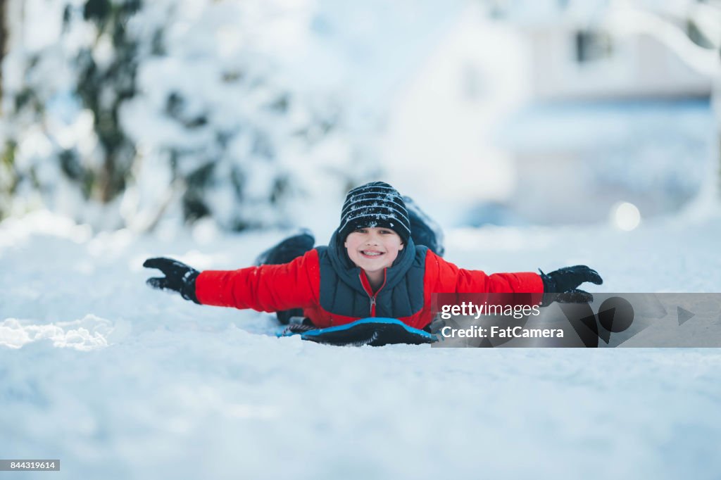 Child sledding in snow