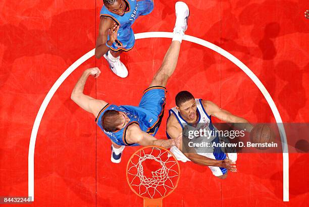 Eric Gordon of the Los Angeles Clippers goes up for a shot against Nenad Krstic of the Oklahoma City Thunder at Staples Center on January 23, 2009 in...