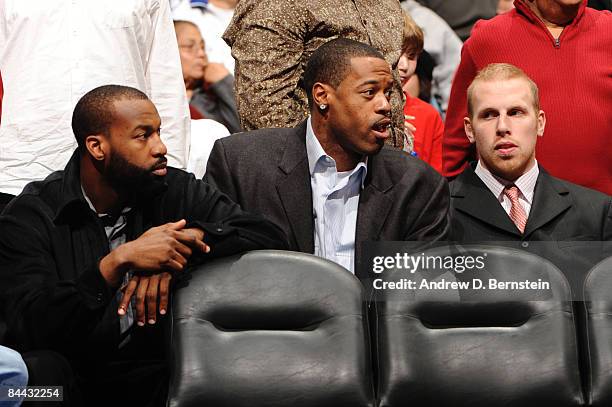 Injured players Baron Davis, Marcus Camby, and Chris Kaman of the Los Angeles Clippers watch from the bench during a game against the Oklahoma City...