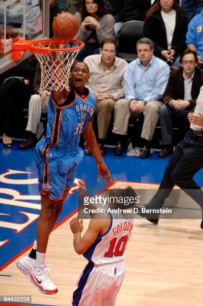 Kevin Durant of the Oklahoma City Thunder dunks while Eric Gordon of the Los Angeles Clippers looks on during their game at Staples Center on January...