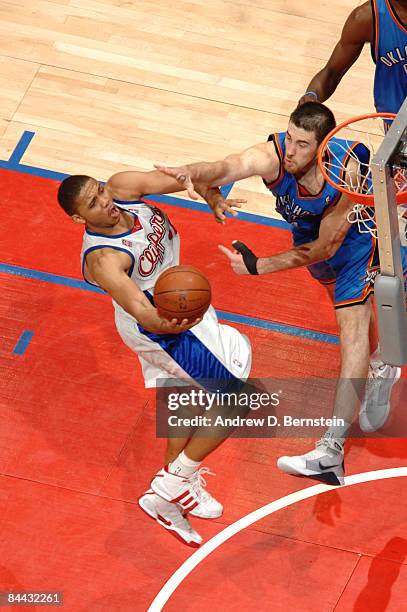 Eric Gordon of the Los Angeles Clippers goes up for a shot against Nick Collison of the Oklahoma City Thunder at Staples Center on January 23, 2009...