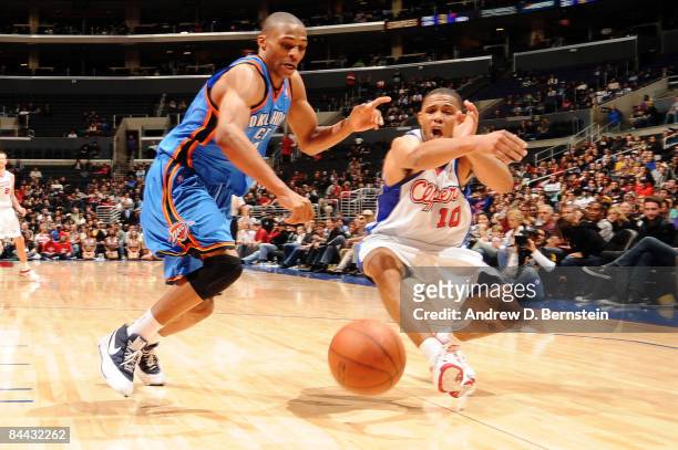 Russell Westbrook of the Oklahoma City Thunder and Eric Gordon of the Los Angeles Clippers chase after a loose ball during their game at Staples...