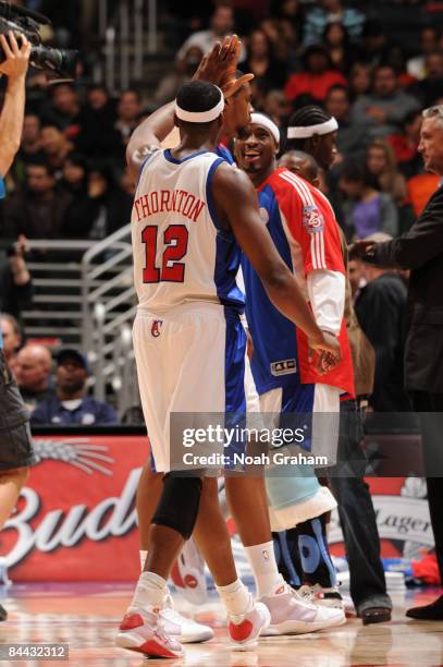 Al Thornton and Ricky Davis of the Los Angeles Clippers slap hands following their victory over the Oklahoma City Thunder at Staples Center on...