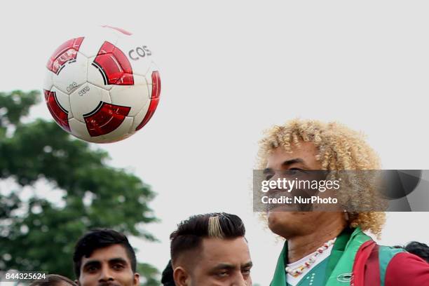 Former Colombian footballer Carlos Valderrama, who played in three World Cup tournaments, gestures during an event ahead of the FIFA U-17 World Cup...