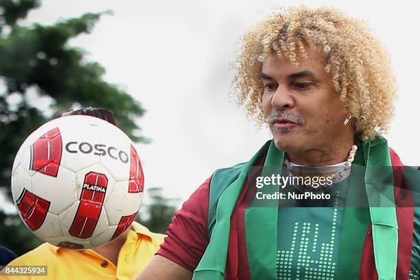 Former Colombian footballer Carlos Valderrama, who played in three World Cup tournaments, gestures during an event ahead of the FIFA U-17 World Cup...