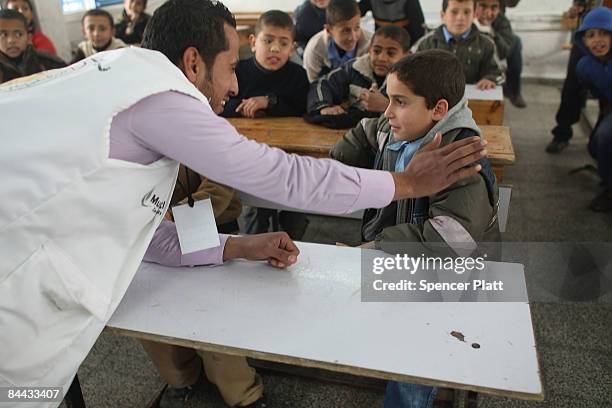 Counselor speaks to a student at Jabalia Prep C Boys School on the first day back to school since the cease-fire with Israel January 24, 2009 in...