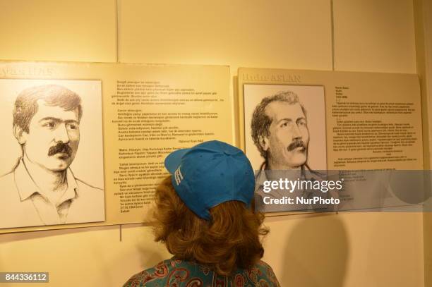 Woman looks at portraits of the victims on the opening day of the September 12 Shame Museum, which is held with the help of the main opposition...