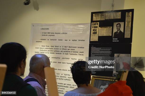 People look at a board on the opening day of the September 12 Shame Museum, which is held with the help of the main opposition Republican People's...
