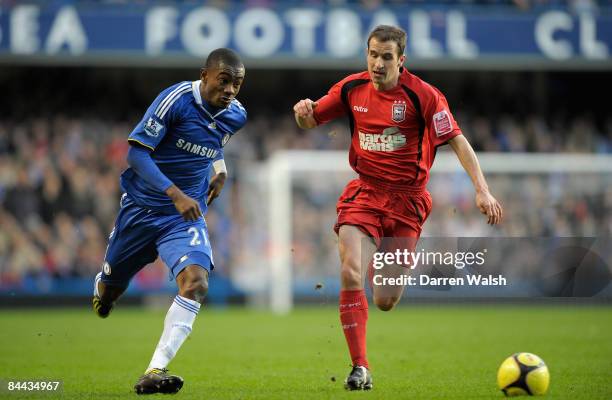 Salomon Kalou of Chelsea chases the ball with David Wright of Ipswich Town during the FA Cup Sponsored by E.on fourth round match between Chelsea and...