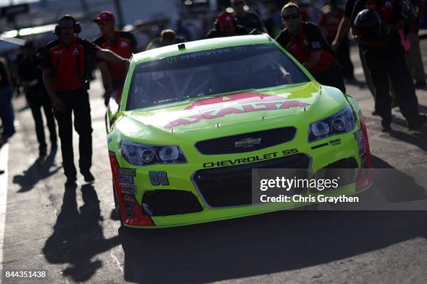 Dale Earnhardt Jr., driver of the AXALTA Chevrolet, sits in his car during qualifying for the Monster Energy NASCAR Cup Series Federated Auto Parts...