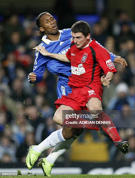 Chelsea's Didier Drogba grimaces as he gets challenged by Ipswich Town's Alex Bruce during the FA Cup 4th round match at Stamford Bridge in London on...