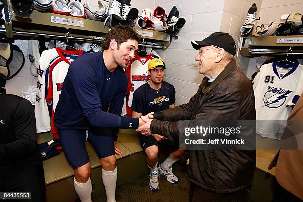 Western Conference All-Star Sheldon Souray of the Edmonton Oilers greets NHL legend Johnny Bower in the locker room prior to the McDonalds/NHL...