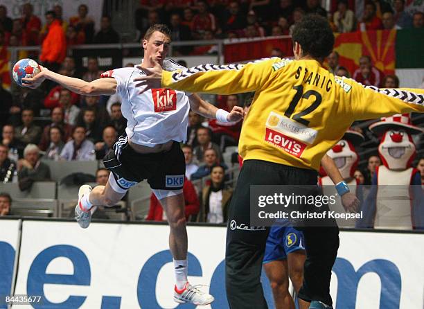 Dominik Klein of Germany scores a goal against Darko Stanic of Serbia during the Men's World Handball Championships main round match group two...