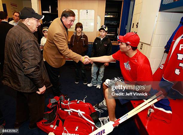Eastern Conference All-Star Carey Price of the Montreal Canadiens greets NHL legend Johnny Bower and Frank Mahovlich in the locker room prior to the...
