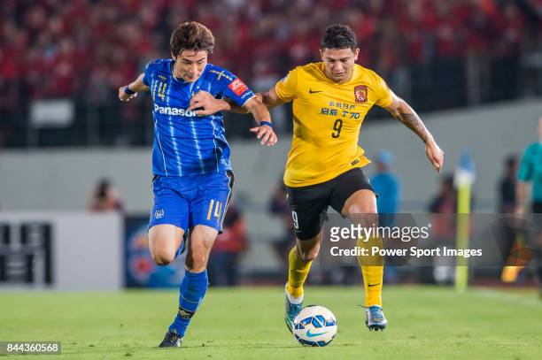 Guangzhou Evergrande forward Elkeson De Oliveira Cardoso fights for the ball with Gamba Osaka defender Yonekura Koki during the 2015 AFC Champions...