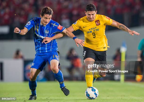 Guangzhou Evergrande forward Elkeson De Oliveira Cardoso fights for the ball with Gamba Osaka defender Yonekura Koki during the 2015 AFC Champions...