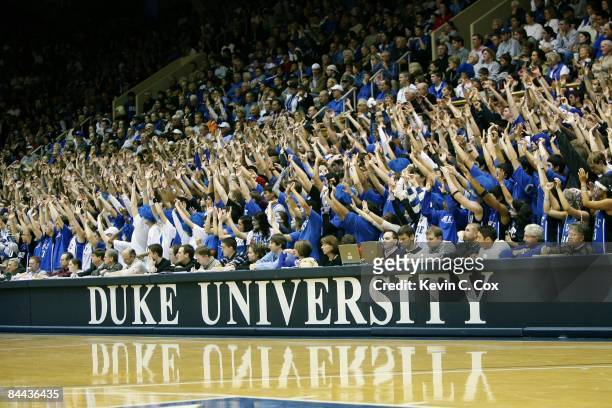 Fans of the Duke Blue Devils raise their arms during the game against the Georgetown Hoyas on January 17, 2009 at Cameron Indoor Stadium in Durham,...