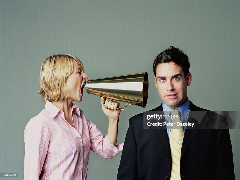 Woman shouting at men with phone