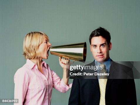 Woman shouting at men with phone Woman shouting at men with phone