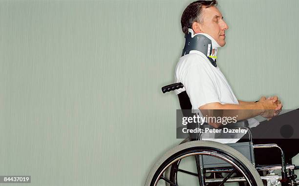 man with neck brace in wheel chair in hospital. - paralysis stock pictures, royalty-free photos & images
