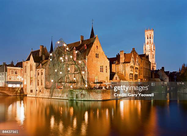 traditional buildings reflected in canal.  - flandres imagens e fotografias de stock