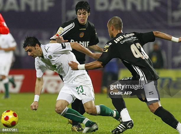 Sporting's Helder Postiga vies with Nacional's Felipe Lopes and Luis Alberto during their Portuguese League football match at Madeira Stadium in...