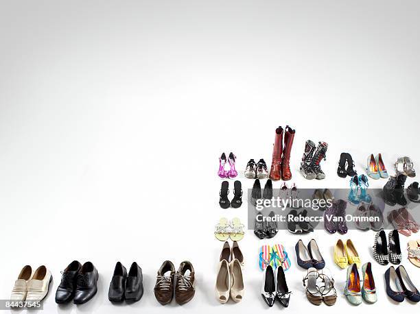 array of various shoe's on white floor - shoes in a row stock pictures, royalty-free photos & images