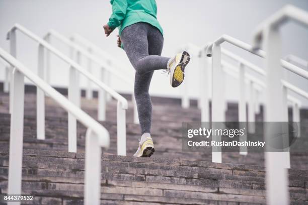 active female sports training on stairs. - hip hopper stock pictures, royalty-free photos & images