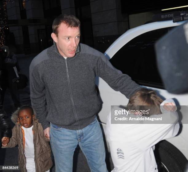 Madonna's former husband Guy Ritchie holds their sons David and Rocco Ritchie's hands as he walks the streets in Manhattan on January 24, 2009 in New...