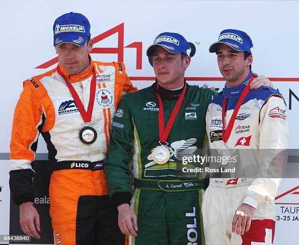 Adam Carroll of Ireland on the podium following his win in the sprint race with 3rd placed Robert Doornbos of the Nehterlands and 2nd place getter...