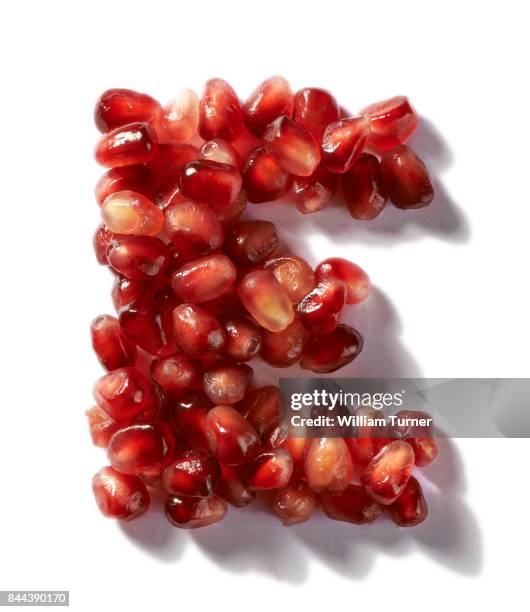 a cut out food image of pomegranate fruit seeds - william turner london stockfoto's en -beelden