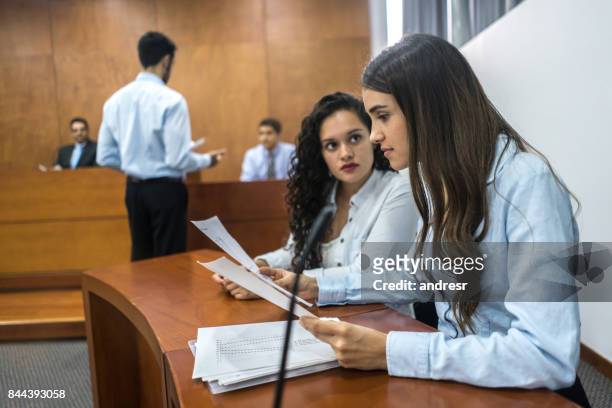 lawyers in trial at the courthouse - legal defense stock pictures, royalty-free photos & images