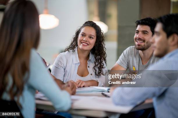 happy young woman studying with a group of friends - round table stock pictures, royalty-free photos & images